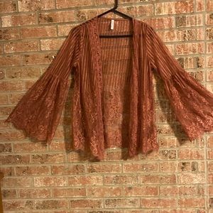 Adorable blush colored lace cardigan.  Looks like altered state apparel.